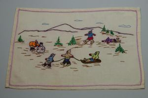 Image of Embroidered placemat with Inuit figures playing